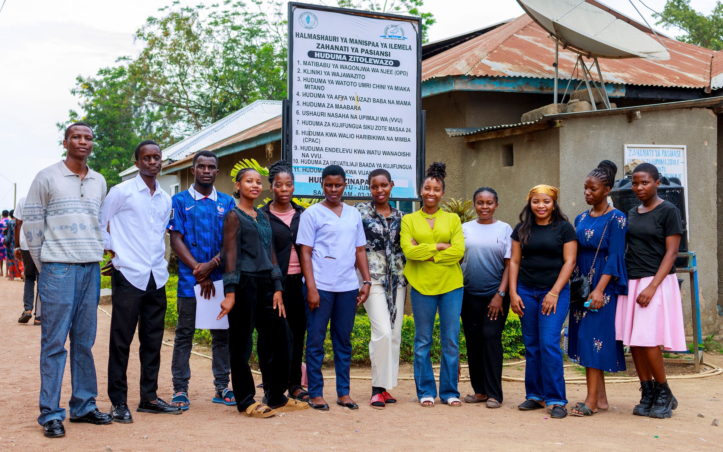 Teens Corridor peer educators and team standing together outside Pasiansi dispensary in Ilemela, Mwanza